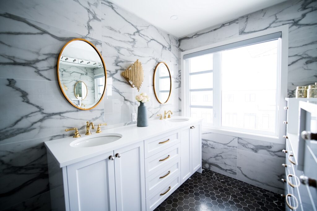 Contemporary bathroom with wooden vanity and round mirror