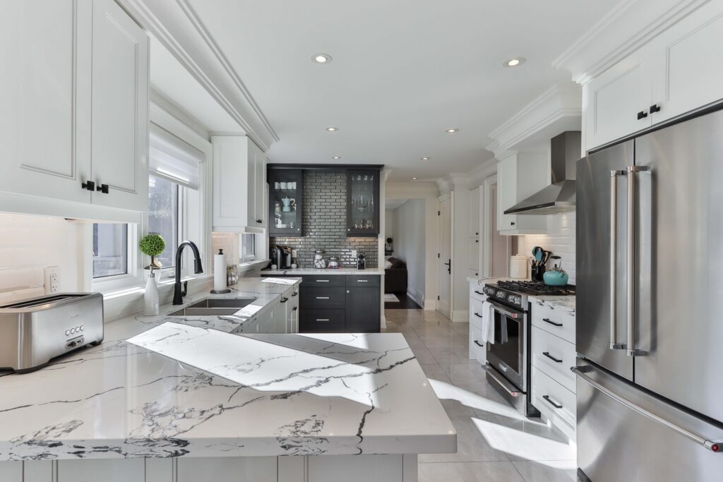 White kitchen interior with small dining table and chairs