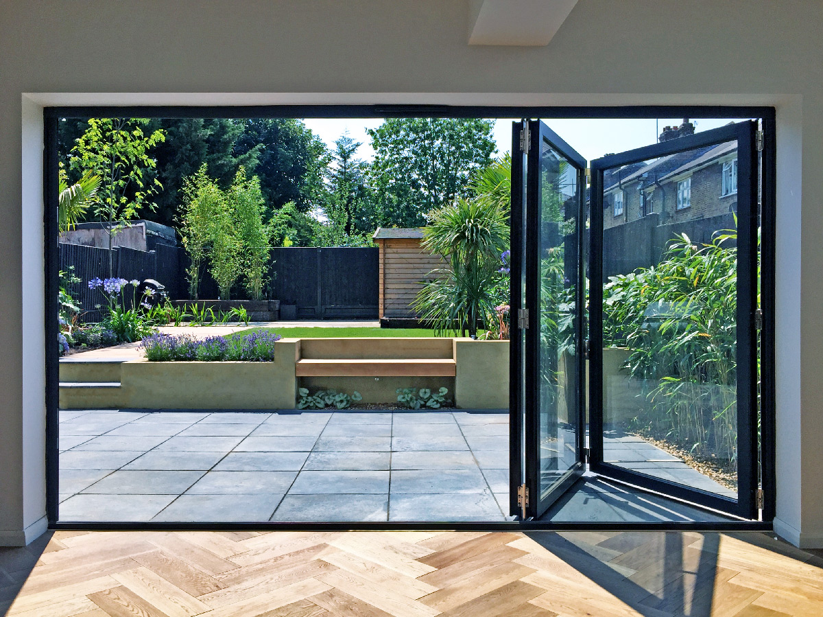 Evening view of patio and pool area accessed by bifold glass doors.