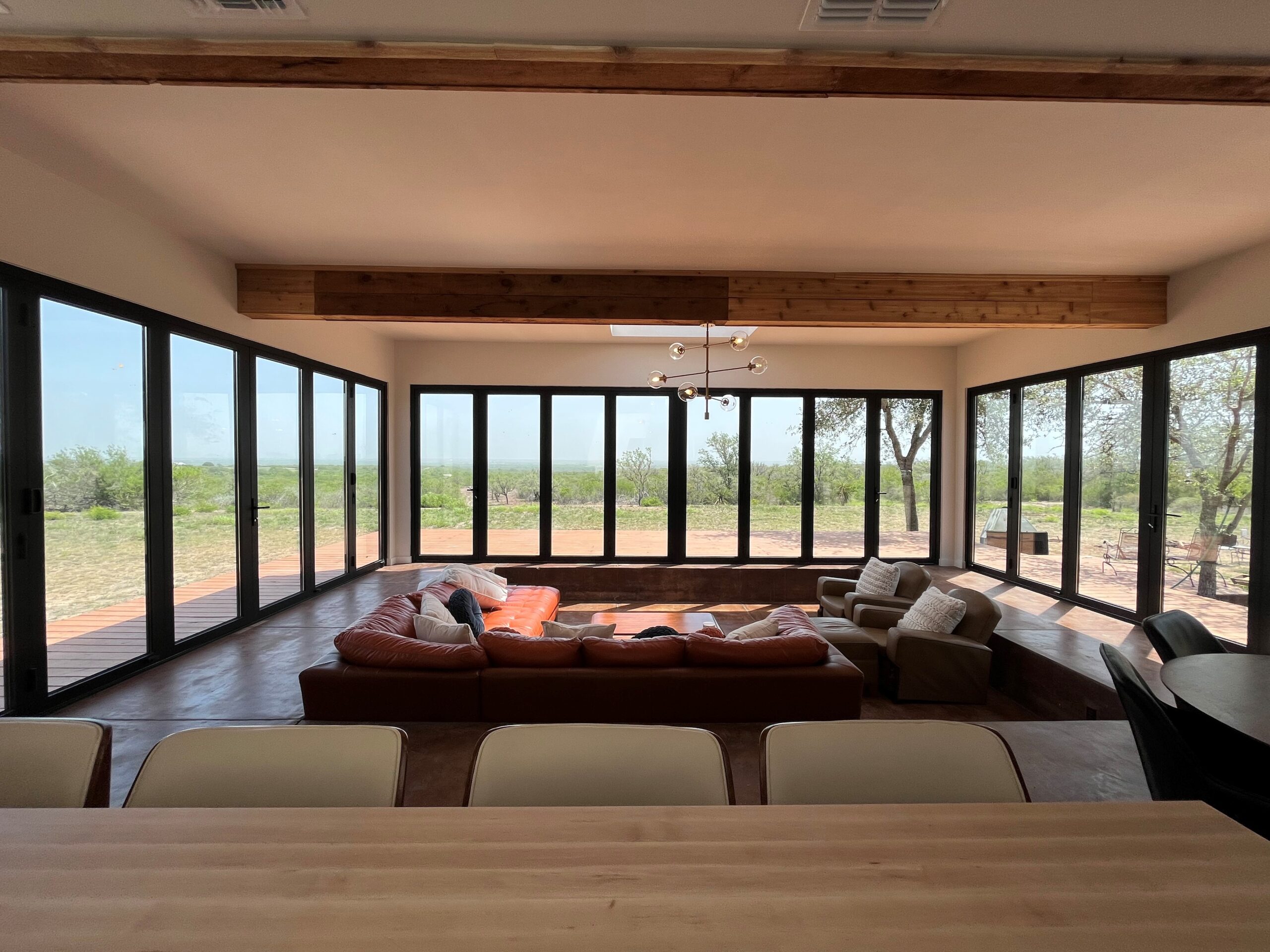 Multi panel aluminum bifold window spanning full width