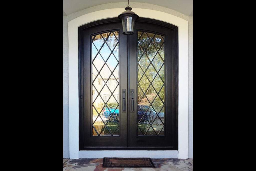 Designer double steel security doors with geometric slot pattern and sleek bar handles.