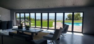 Black glass bifold entry door with centre access panel