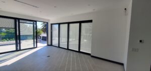 Modern living room with glass bifold doors to lawn