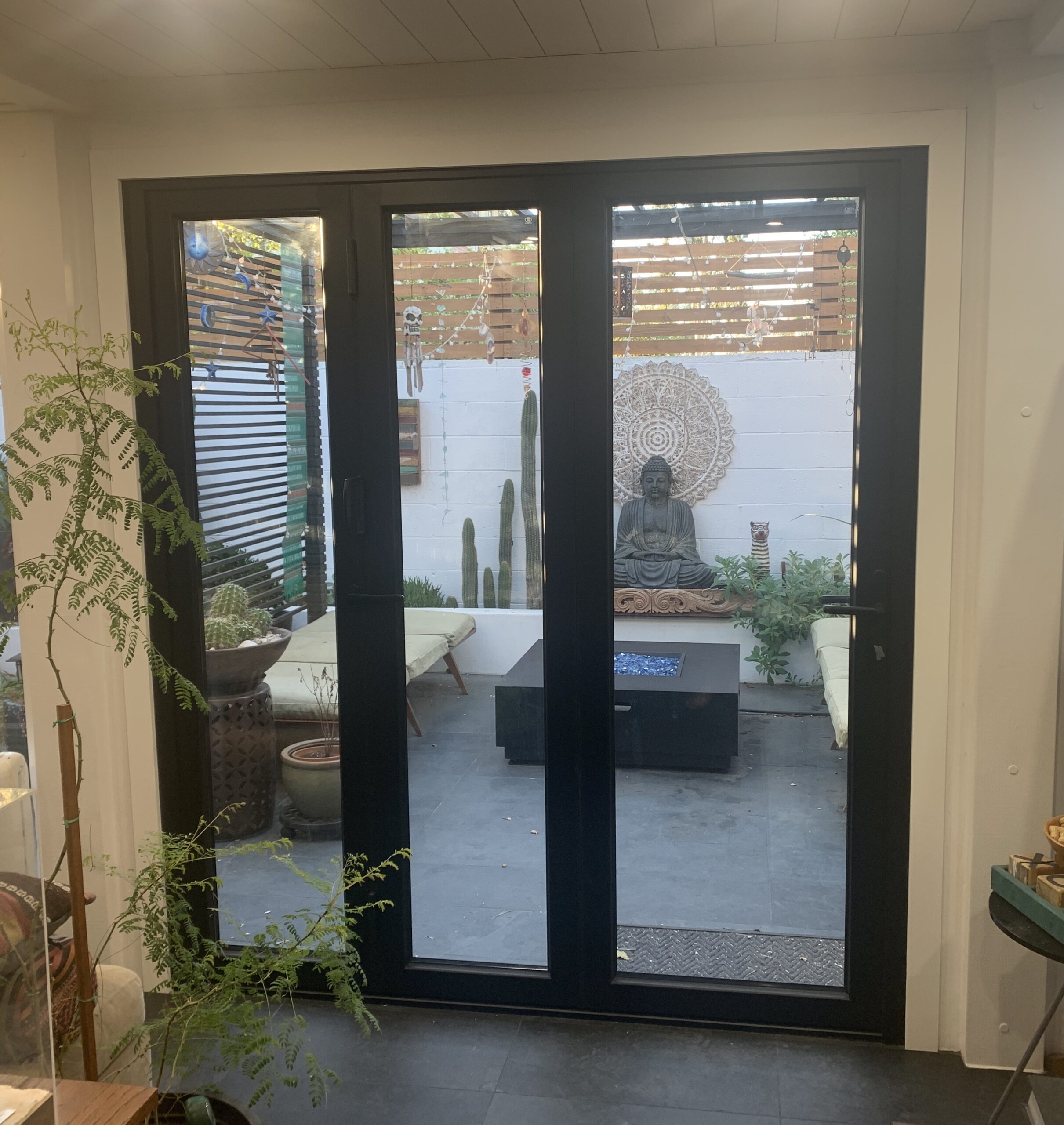 Modern living room glass doors to lush patio.