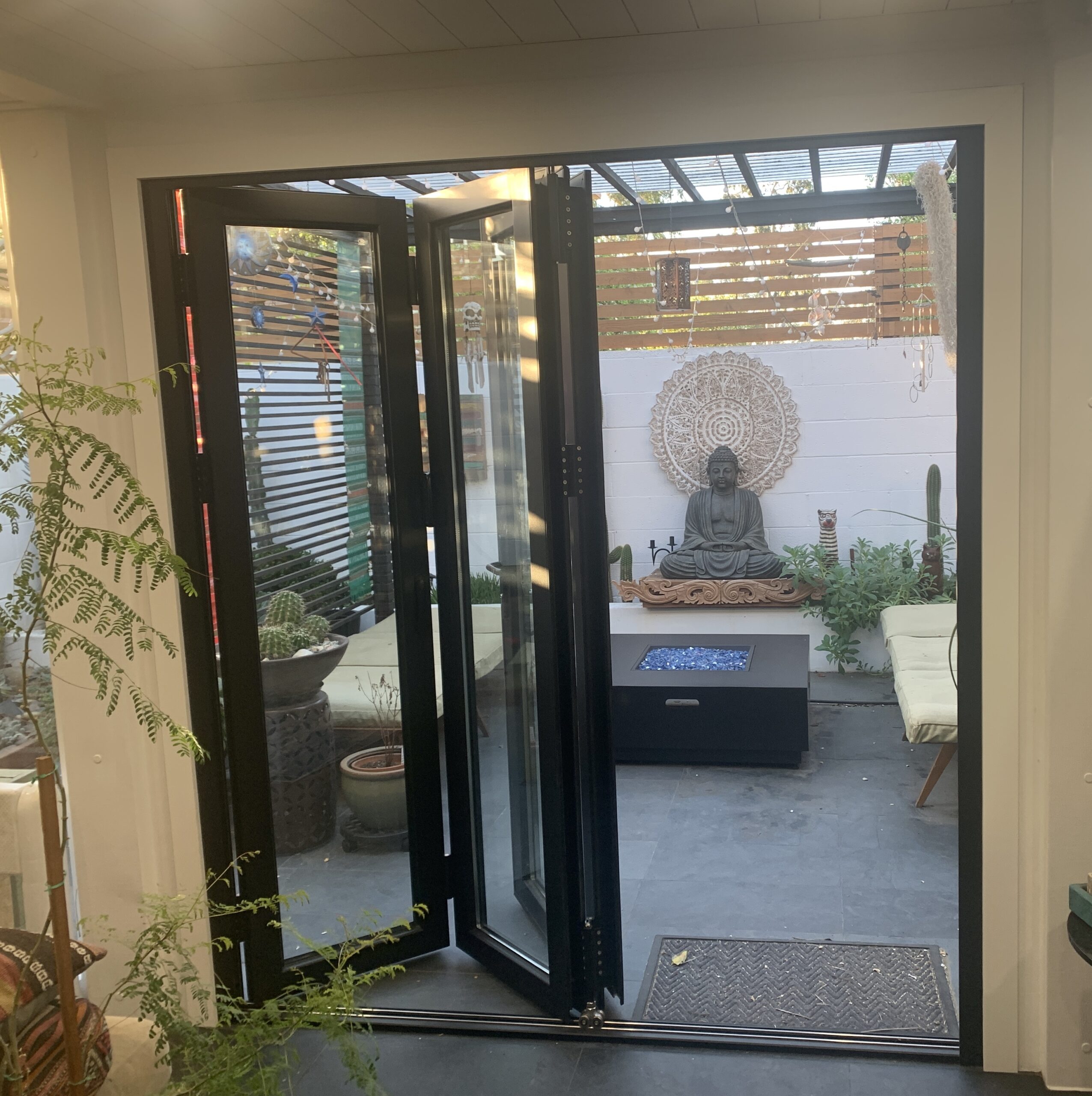 Decorative black iron door with glass panel.