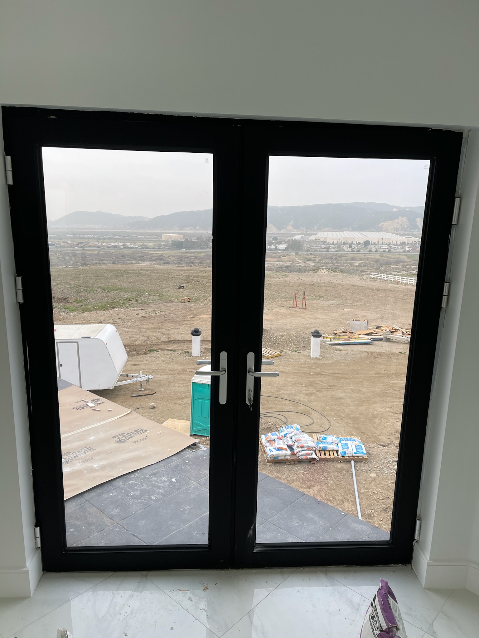 Modern bifold door design with clear glass and black frame.