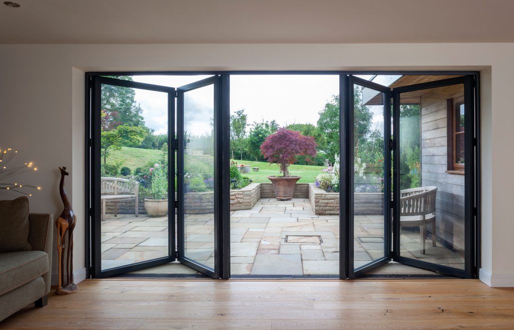 Outdoor lounge with open folding doors