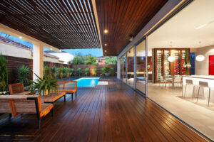 Sleek indoor lounge with direct pool and garden access