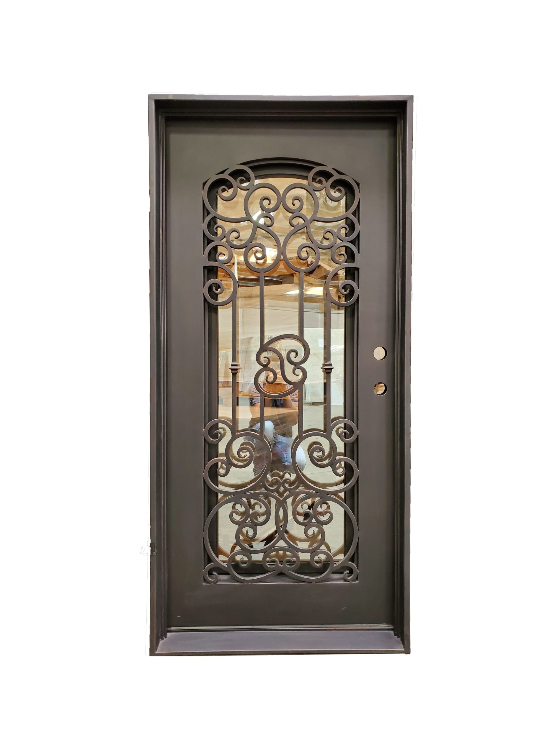 Decorative wrought iron entry door with scrollwork on solid frame