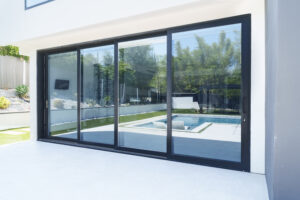 Modern living room showcasing sleek black-framed bifold doors opening to natural light